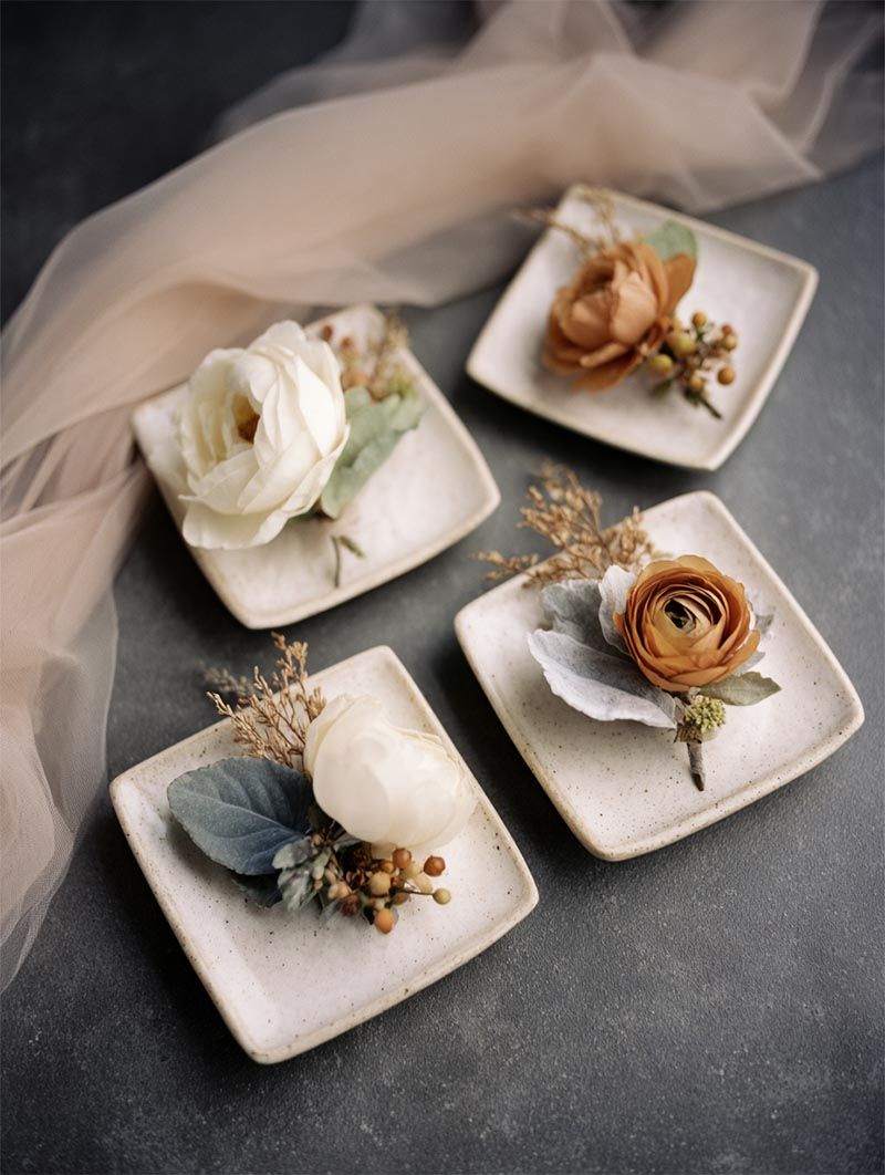 Hand-tied groomsmen boutonnieres of ivory and caramel garden roses styled on artisan ceramic trays - fine art wedding florals